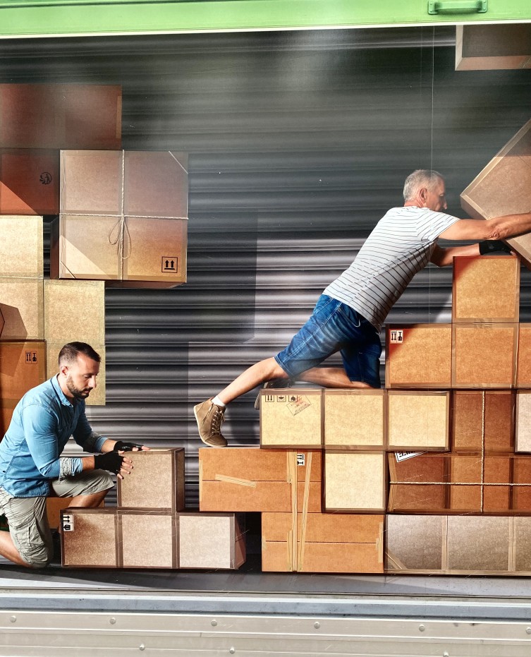 https://blog.protectionselfstorage.com/wp-content/uploads/2022/02/urban-scene-men-outdoor-moving-movers-tetris-moving-day-moving-boxes-professional-movers-adult-tetris_t20_nXbmWg.jpg