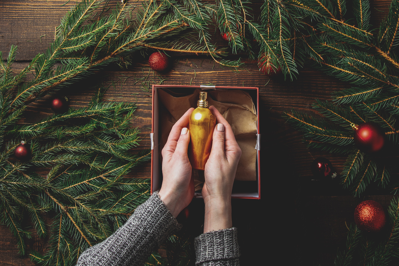 hands packing up christmas decorations to put in seasonal storage