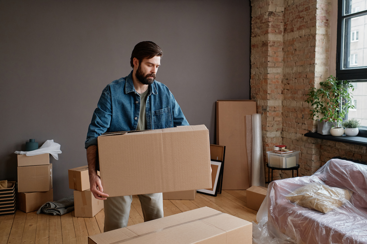 man preparing for moving in the rain